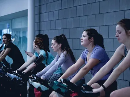 Indoor cycling class in a dark studio