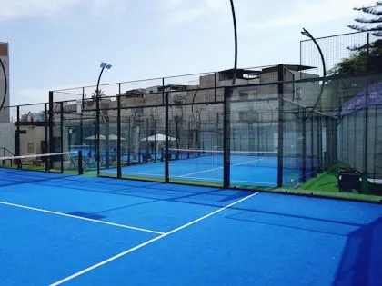 Blue padel court in the evening
