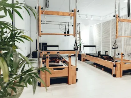 Empty reformer Pilates studio with plants and daylight