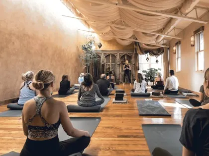 Yoga class seen from the back of the room