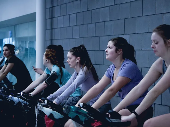 Indoor cycling class in a dark studio