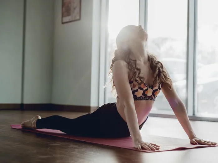 Woman stretching in a bright yoga studio